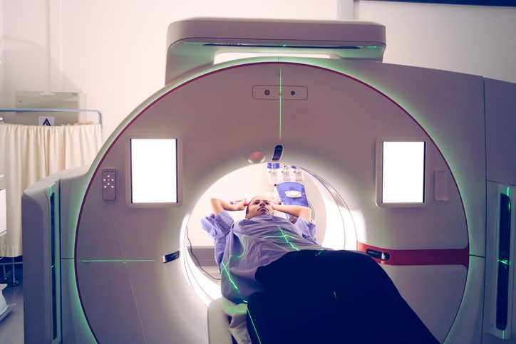 Person undergoing MRI scan in medical facility.