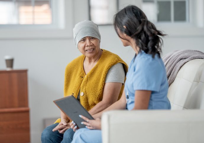 Nurse talking with a patient on couch.