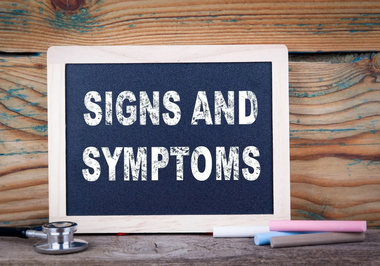 Chalkboard with "Signs and Symptoms" text.