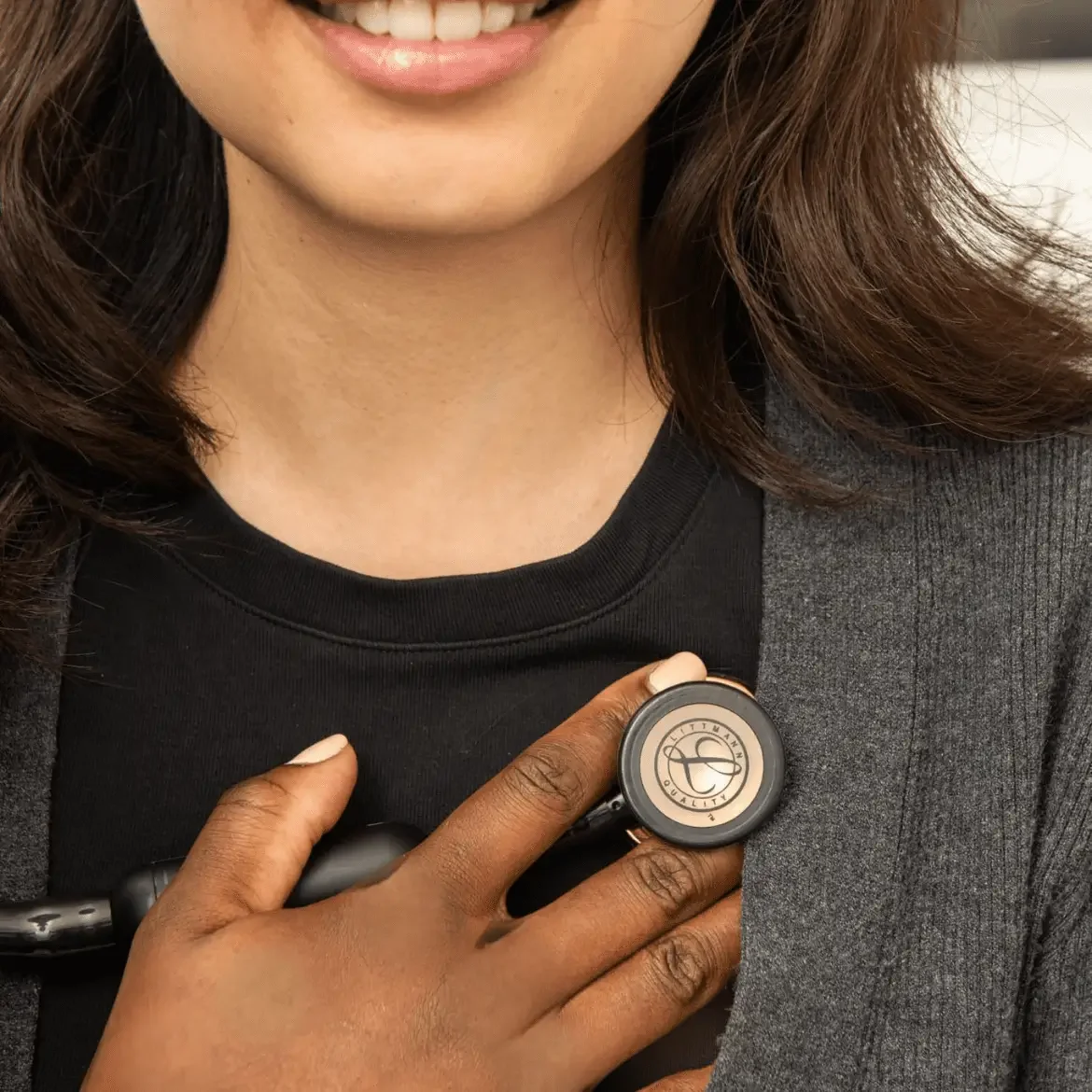 Doctor using stethoscope on woman's chest.